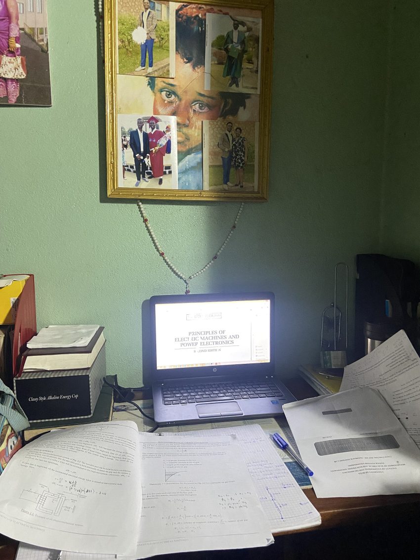 Student using AI study tools on a laptop with books and notes at a desk in a bright workspace