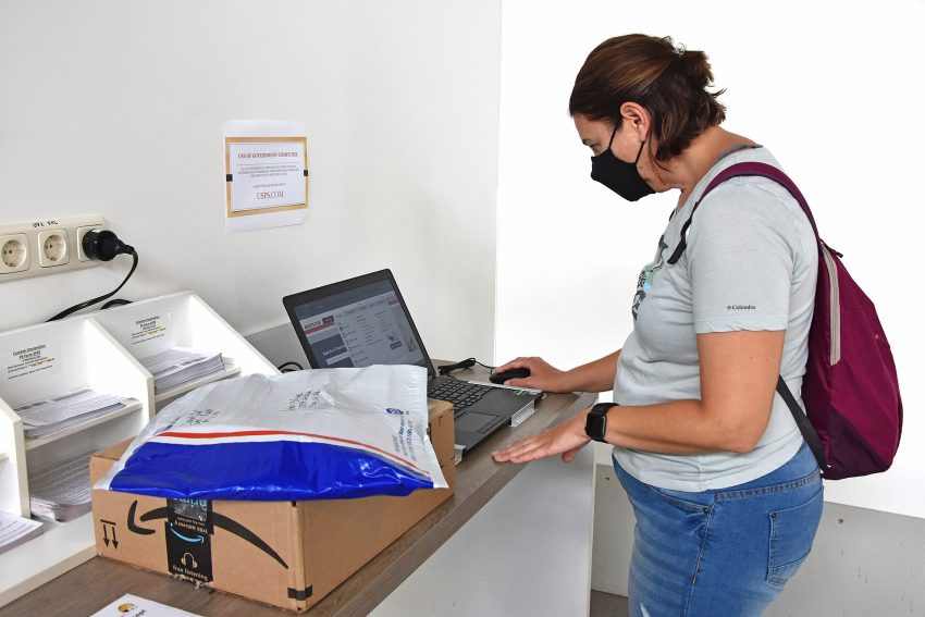 Person building an online form on a laptop in a modern office workspace