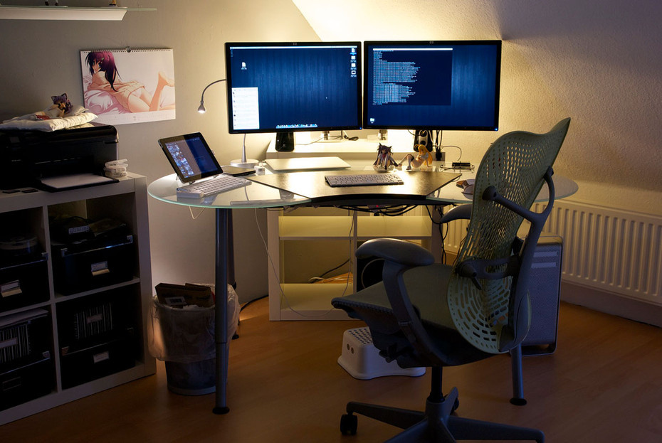 MacBook on a desk with documents in a home office workspace